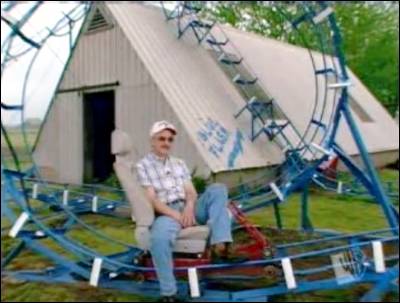 A man who made a roller coaster that makes one turn in his garden