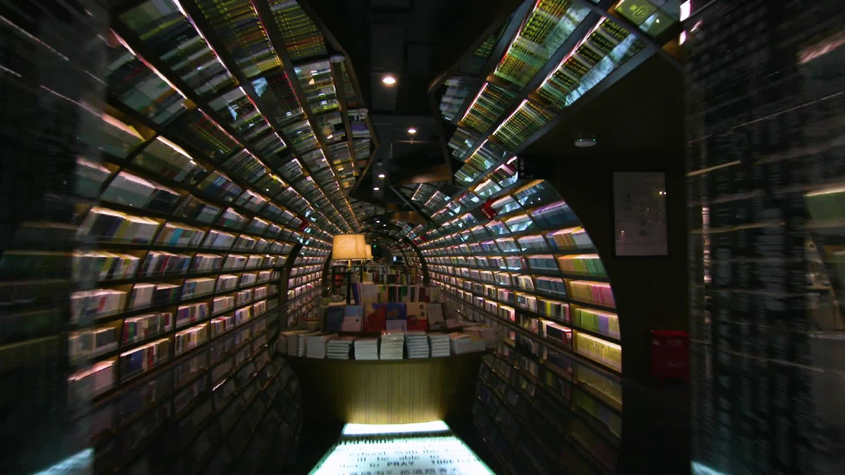 A bookstore with an innumerable bookshelf tunnel and an upside-down bookshe...